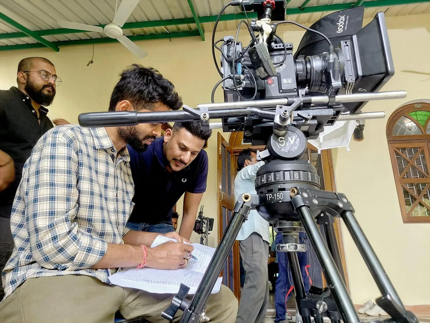 Writing up the shot list beside the camera