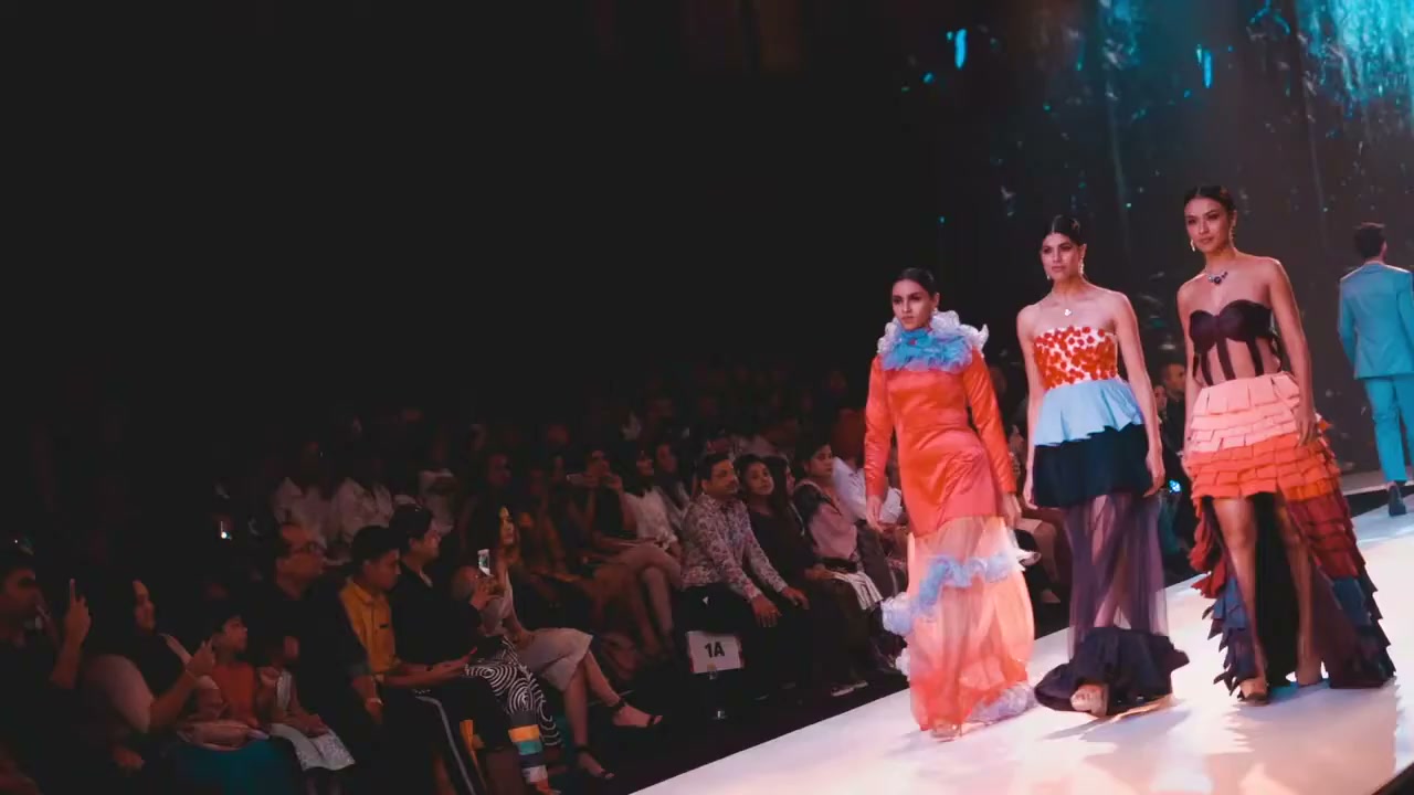 Models on the runway, audience either side
