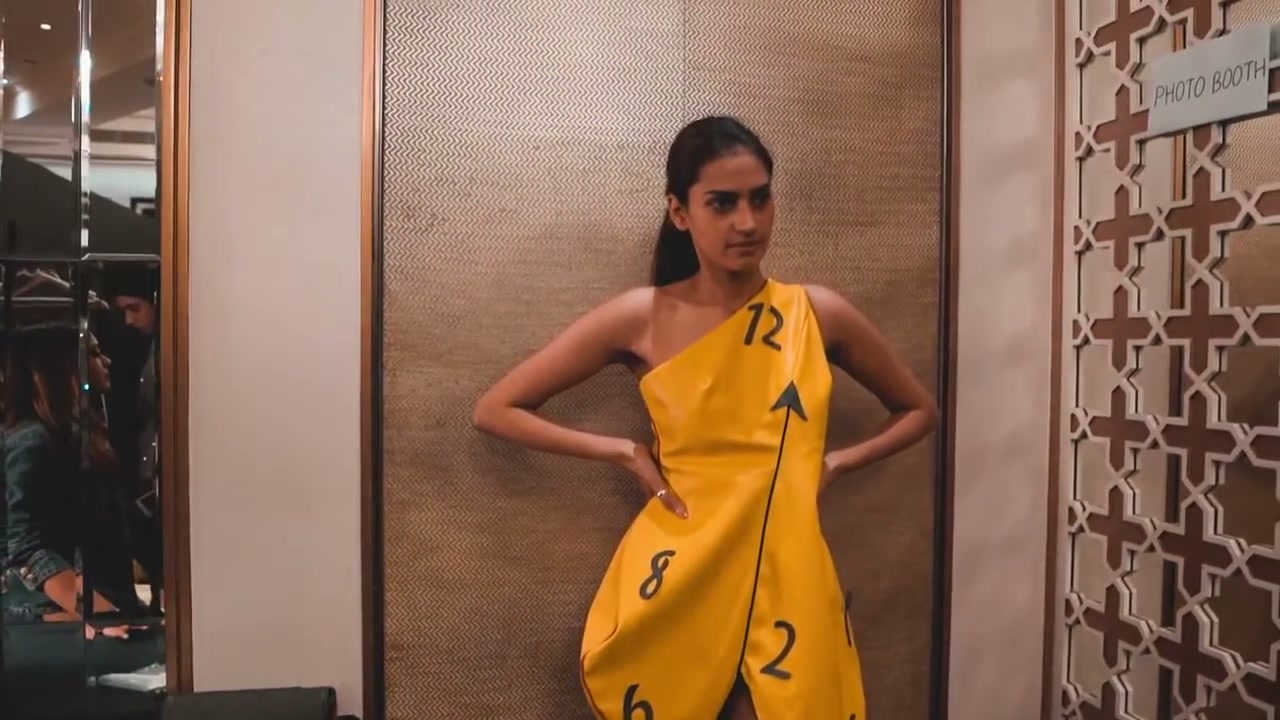 Model in a yellow clock dress backstage