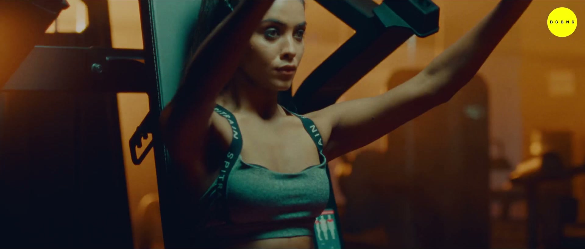 Woman on the gym machine in amber light