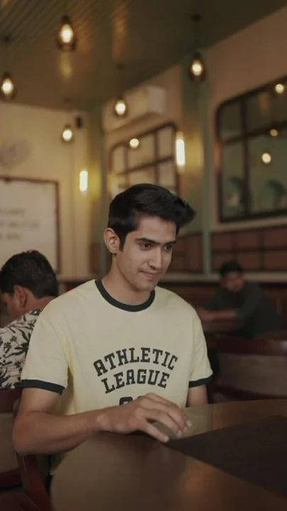 A young man at a café table