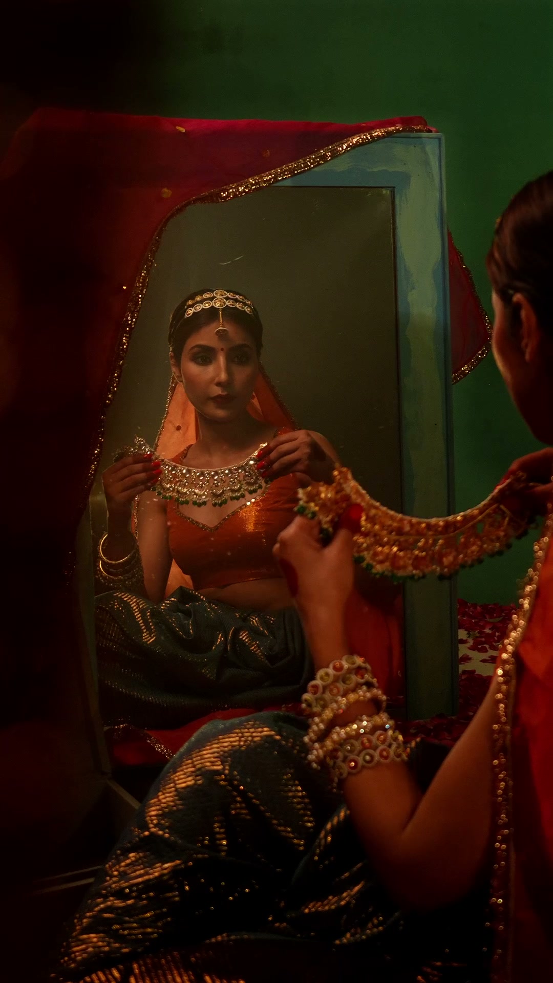 At the mirror holding the necklace