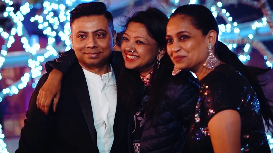 Guests posing together under fairy lights