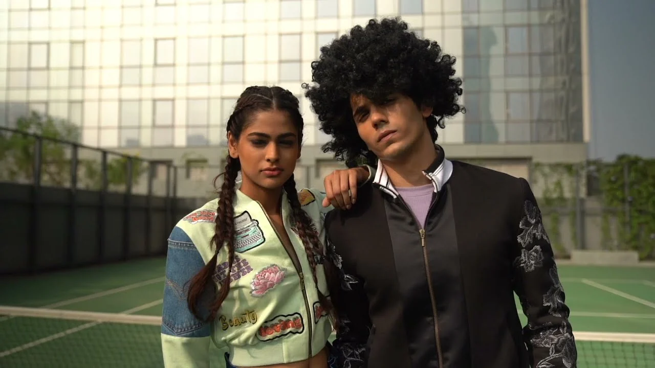 Two models posing on a court
