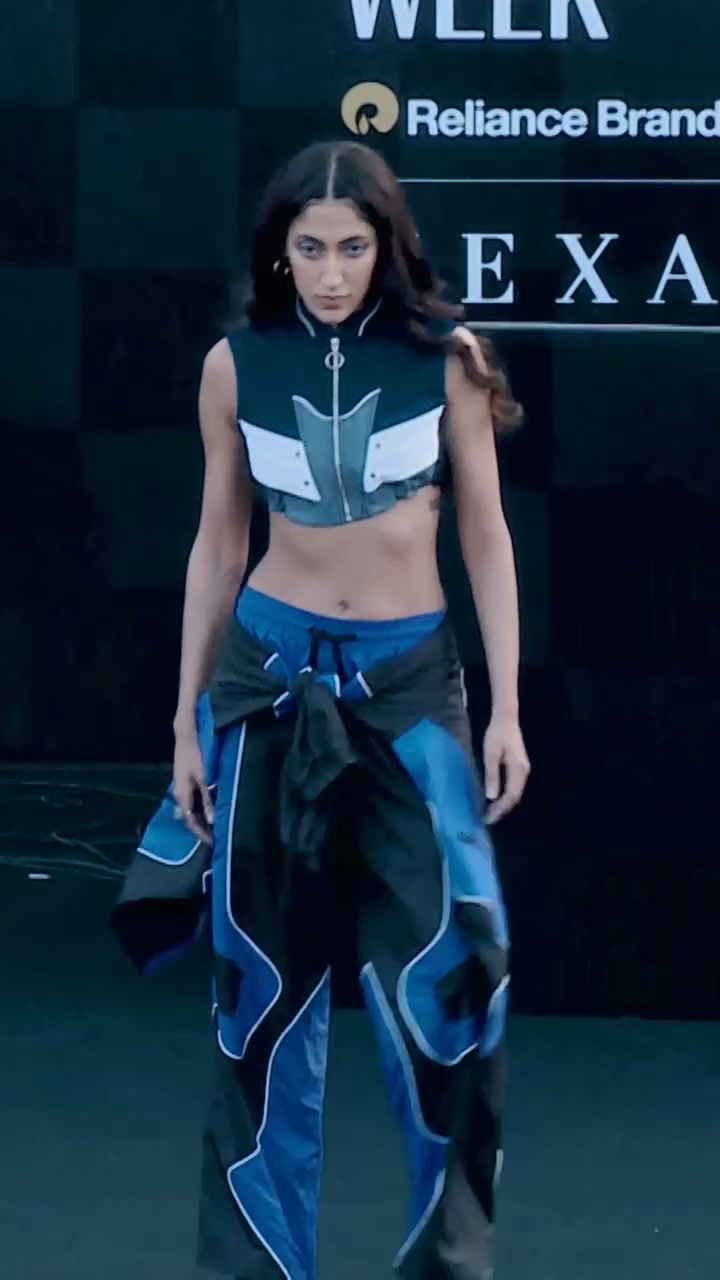 Model in blue racing separates walking