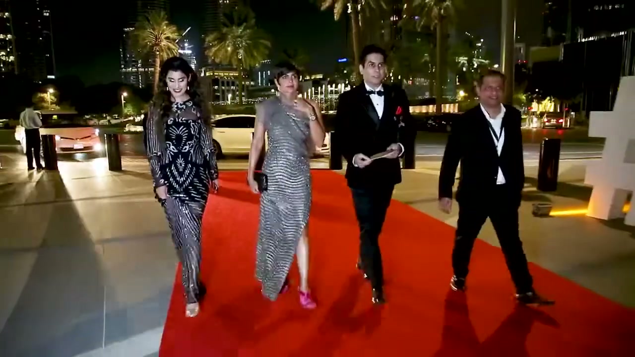 Guests arriving on the red carpet at night