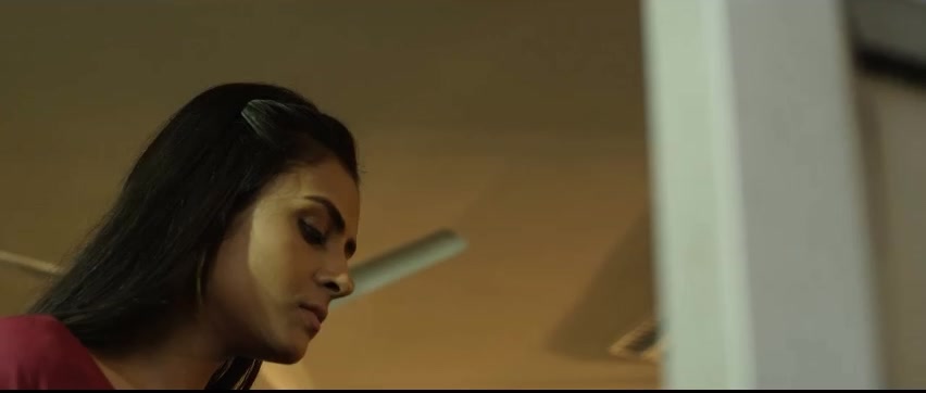 Woman in profile at her desk
