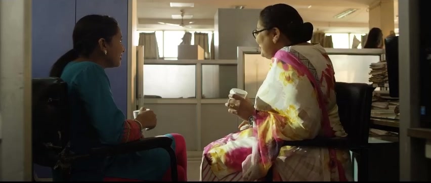 Two colleagues talking over tea