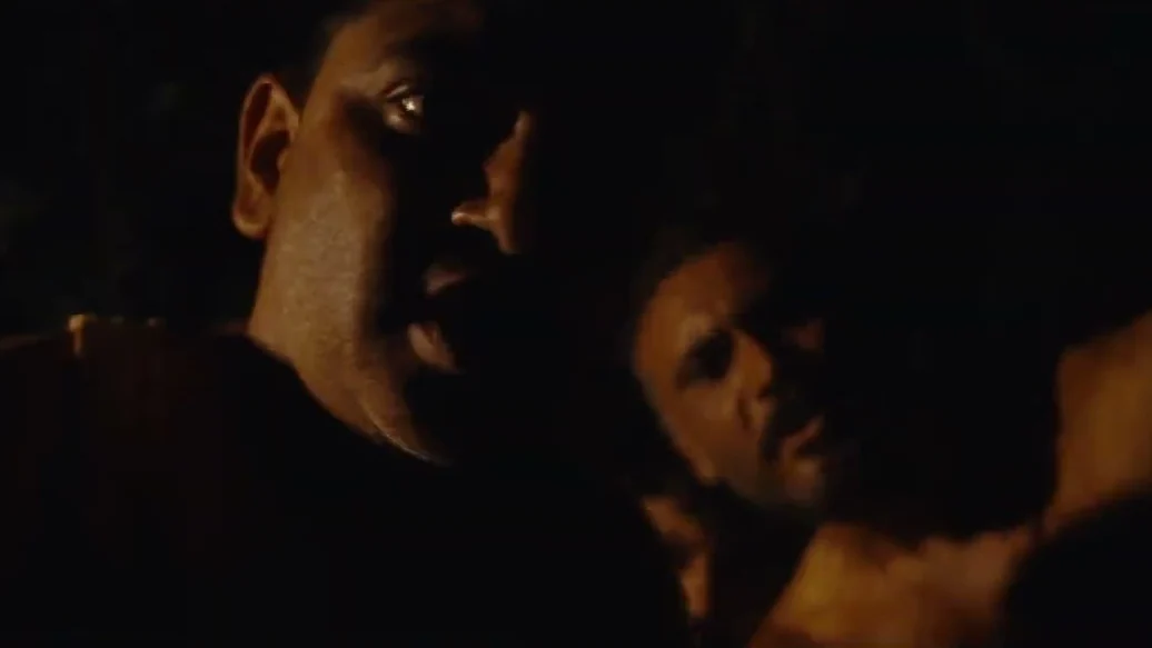 Two men in low light