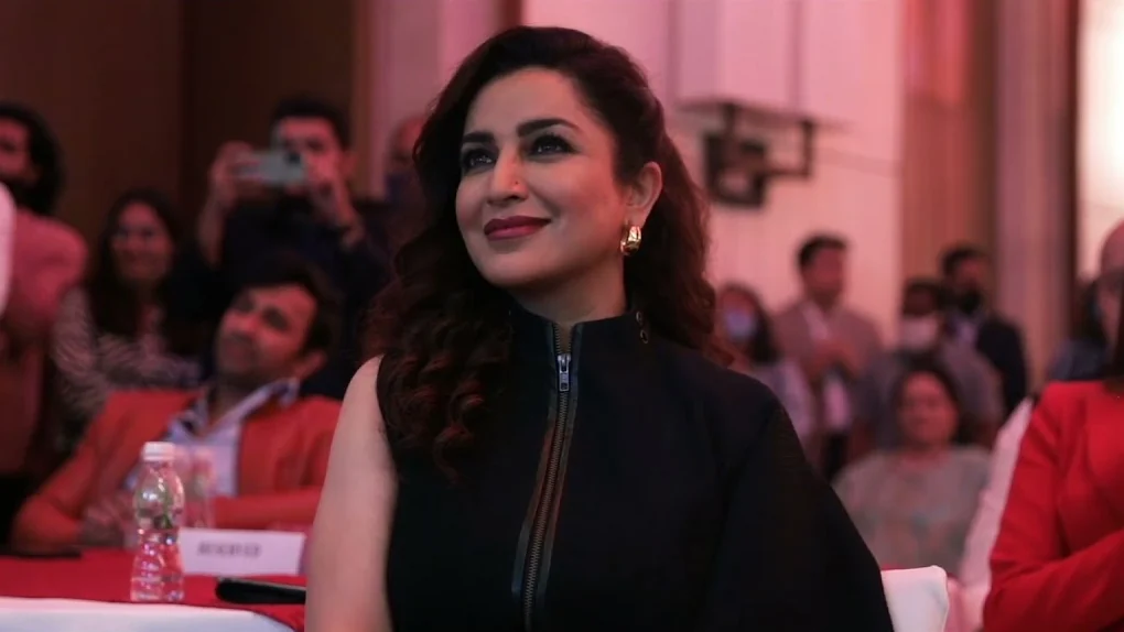 A guest smiling in the audience
