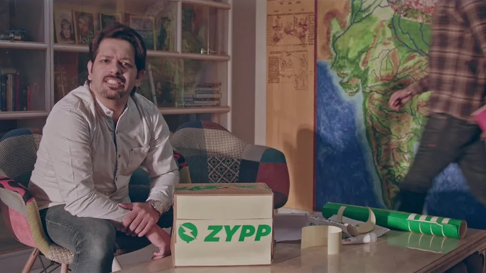Two men at a desk with a Zypp box